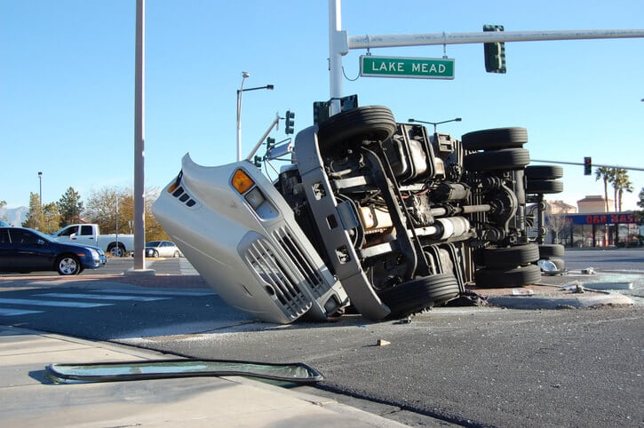 a bad truck crash that left a white truck badly damaged and on its side