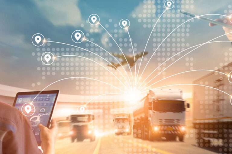 a man looks at a fleet of trucks holding a digital pad