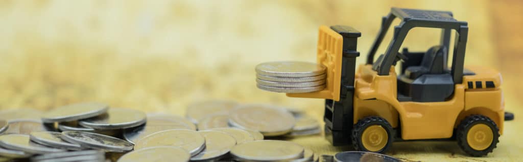 a small forklift lifts some quarters on a yellow background