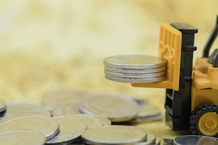 a small forklift lifts some quarters on a yellow background