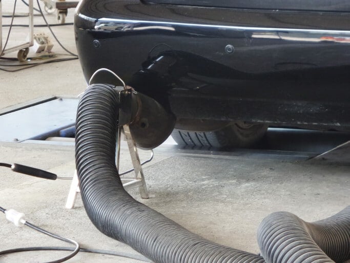 A government fleet vehicle gets a smog emissions test in a garage - Government Fleet Management.