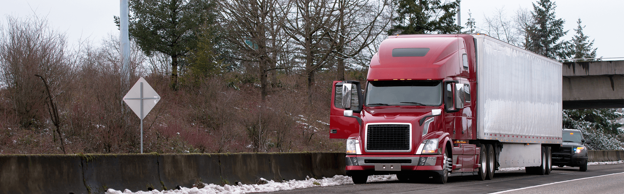 police pull over red truck for road inspection