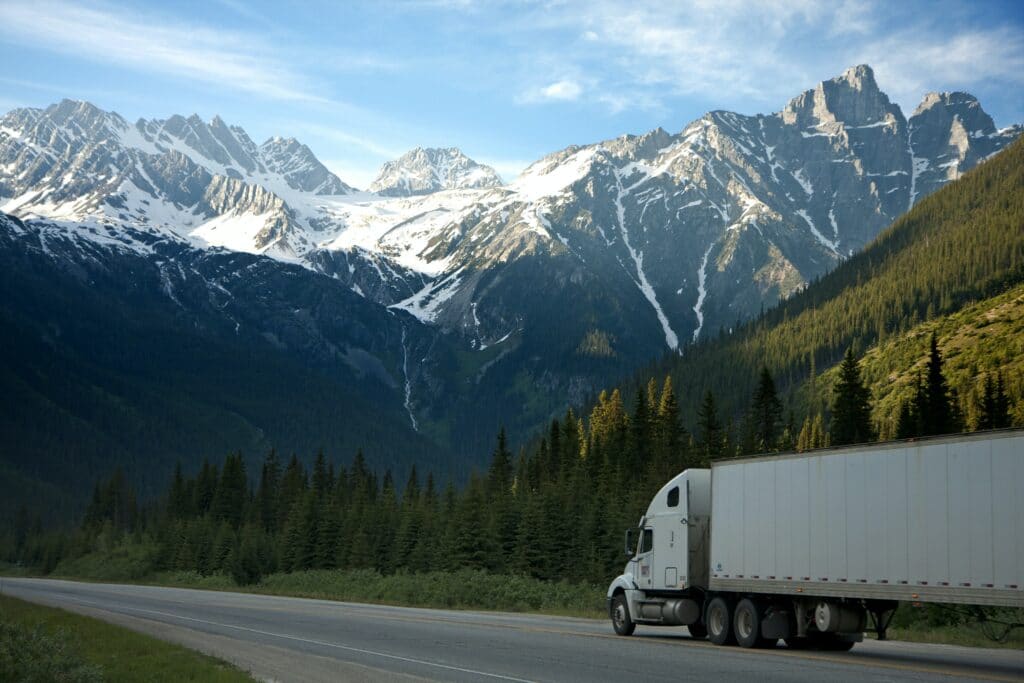 Semi truck driving on highway in the mountains