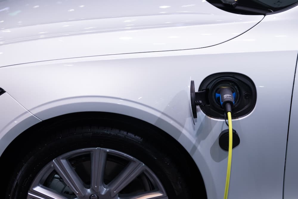 EV charging operations: EV plug in a white car