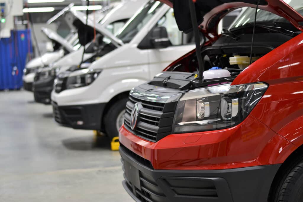 delivery vans with open hoods in garage