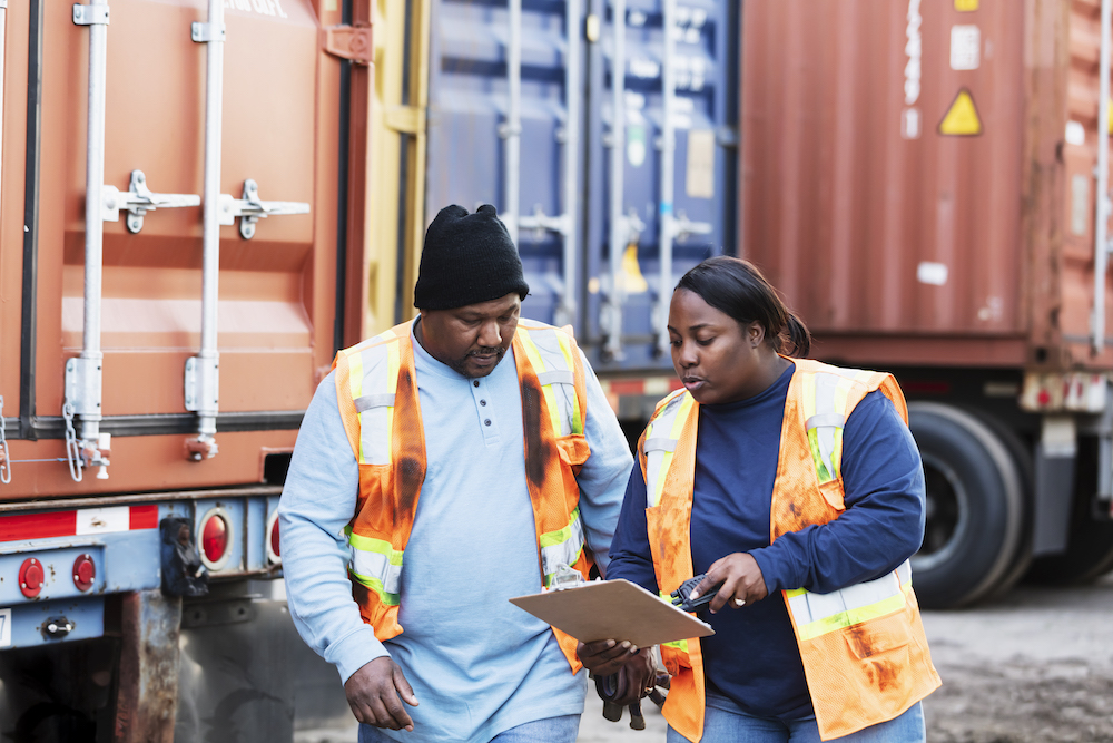 Two employees discussing a DVIR form