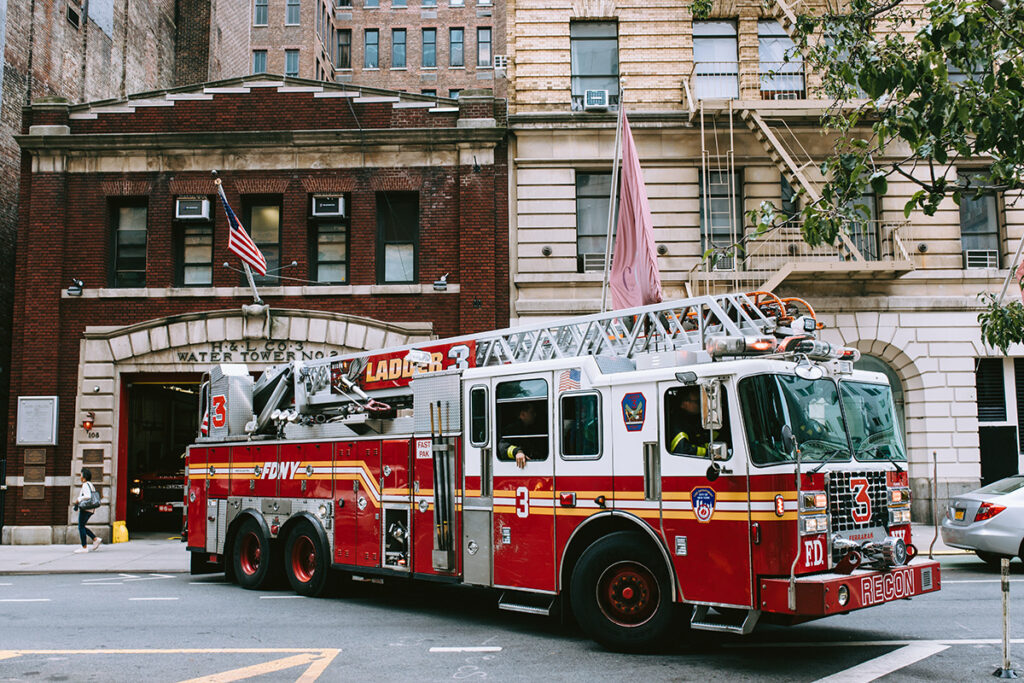 Fire Department ladder trucking in New York leaving the fire station.