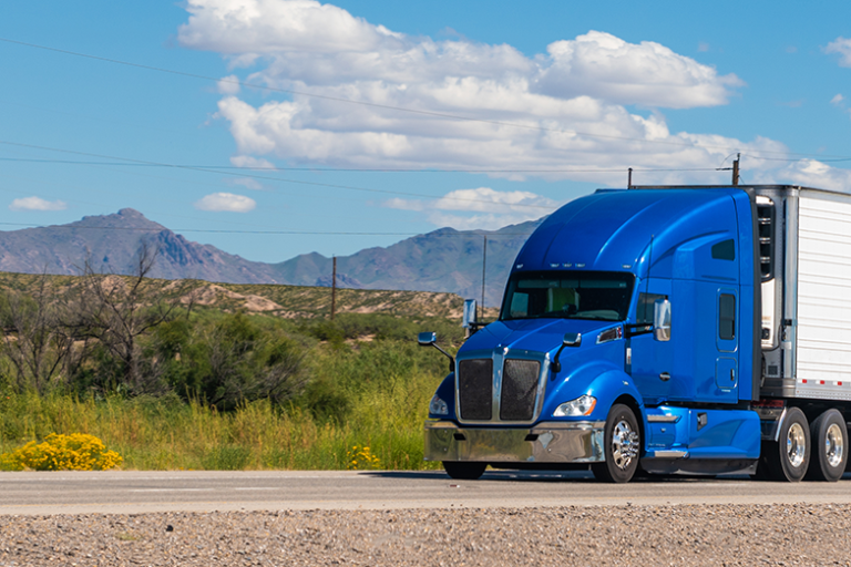 Blue semi-truck on a highway