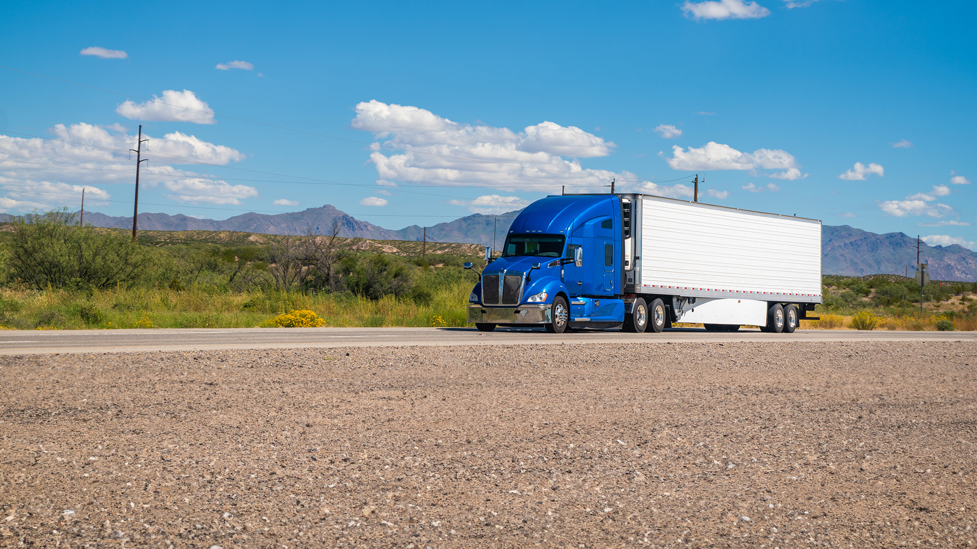 Blue semi-truck on a highway