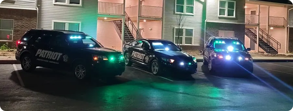 Patriot Protection Services patrol cars at an apartment complex.