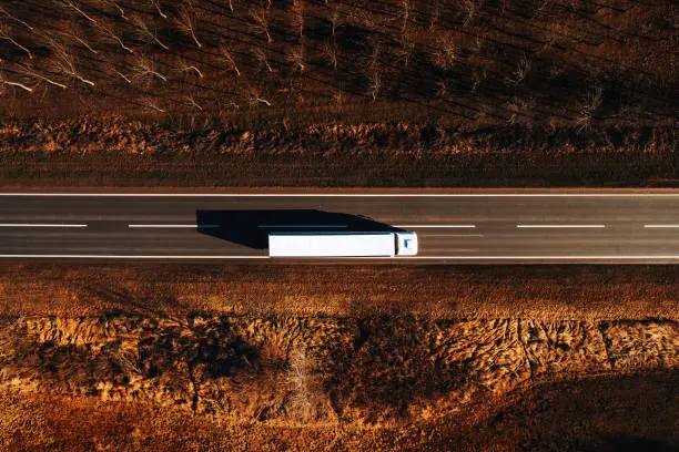 Overhead drone view of a truck on the highway