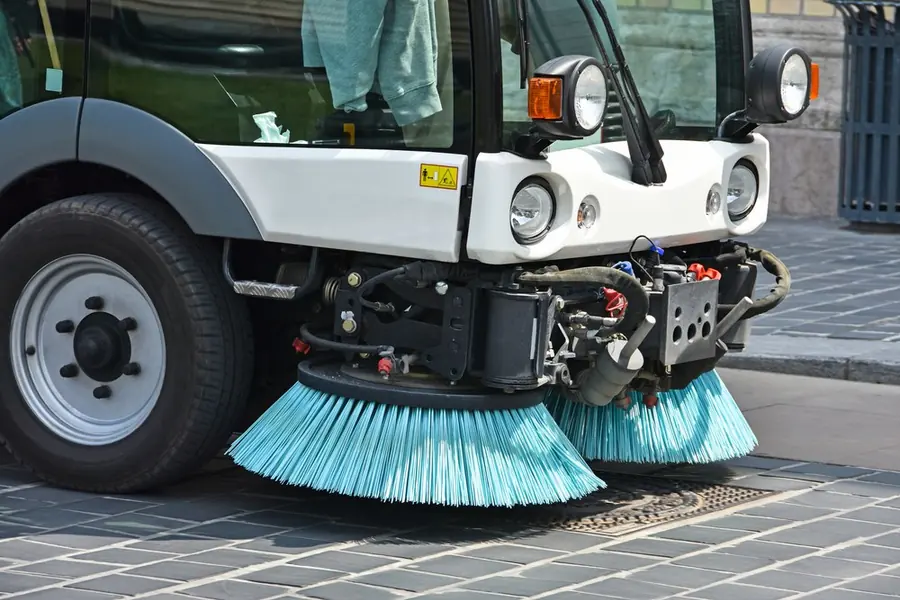 Municipal street sweeper at work