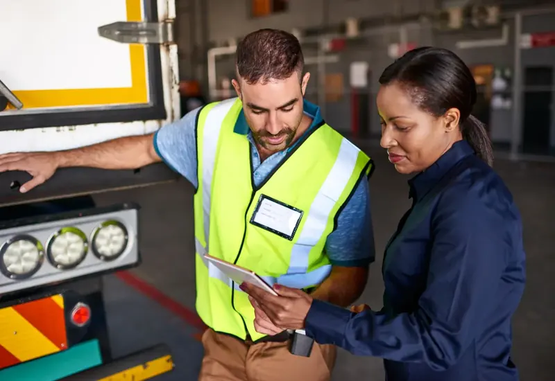 Driver and fleet manager reviewing an event together on a tablet